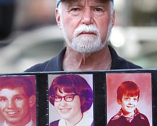 Steve Spaner, of Survivors Network of Those Abused by Priests, holds a paper board featuring photos of people who said they were abused by Catholic priests when they were children. Spaner and wife Judy Jones met with reporters Tuesday in front of Ohio Attorney General Mike DeWine’s West Federal Street offices to urge DeWine to launch an investigation into Ohio dioceses, similar to the recent Pennsylvania state inquiry.
