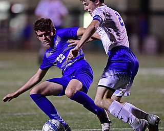 HUBBARD, OHIO - OCTOBER 9, 2018: Poland's Brennen Testa knocks Hubbard's Jacob Gulu out of the way to play the ball during the first half of their game, Tuesday night at Hubbard Eagles Stadium. DAVID DERMER | THE VINDICATOR