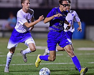 HUBBARD, OHIO - OCTOBER 9, 2018: Hubbard's AJ Trobek dribbles the ball ahead of Poland's Sam Scotford and Justice Gonzalez during the second half of their game, Tuesday night at Hubbard Eagles Stadium. DAVID DERMER | THE VINDICATOR