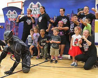 William D. Lewis The Vindicator Marvel character Black Pantherposes with a group of children during 10-10-18 event at YARS.