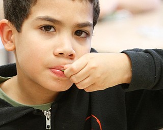 Michael Carson, Martin Luther King Elementary second-grader in the Youngstown City Schools, tries snow peas as a 2 p.m. snack Wednesday afternoon.