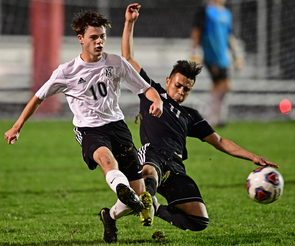 CAMPBELL, OHIO - OCTOBER 9, 2018: Crestview's Daven Manley kicks the ball away from Campbell's Henry Perdomo Mejia during the first half of their game, Wednesday night at Campbell High School. DAVID DERMER | THE VINDICATOR