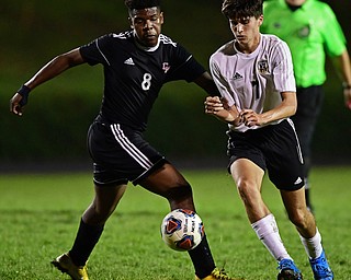 CAMPBELL, OHIO - OCTOBER 9, 2018: Crestview's Cory Dewell and Campbell's Iree Carter battle for the ball during the first half of their game, Wednesday night at Campbell High School. DAVID DERMER | THE VINDICATOR