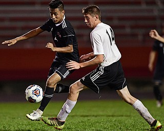 CAMPBELL, OHIO - OCTOBER 9, 2018: Campbell's Victor Orozco moves the ball ahead of Crestview's Colt Crane during the first half of their game, Wednesday night at Campbell High School. DAVID DERMER | THE VINDICATOR