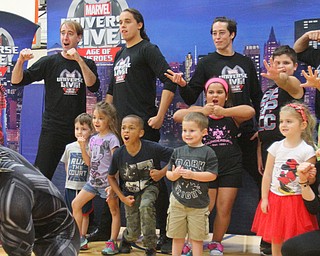 Marvel character Black Panther entertains a group of children of Youngstown Air Reserve Station personnel, who assumed their own poses with stunt men and women starring in Marvel Universe LIVE! Age of Heroes cast this weekend at Covelli Centre Youngstown. The Marvel heroes were at the air base Wednesday.

