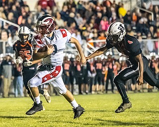 DIANNA OATRIDGE | THE VINDICATOR  Niles' Zack Leonard (8) eludes the grasp of Howland's Cartier Yancy (4) and rushes to the end zone for a touchdown during their game at Lombardo Field on Thursday.