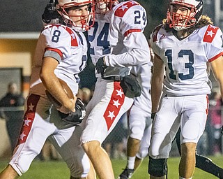 DIANNA OATRIDGE | THE VINDICATOR  Niles' Zack Leonard (8) is met with congratulations by his teammates, Chase Sudzina (24) and Jason Gibson (13), after scoring a touchdown in their game against Howland at Lombardo Field on Thursday.