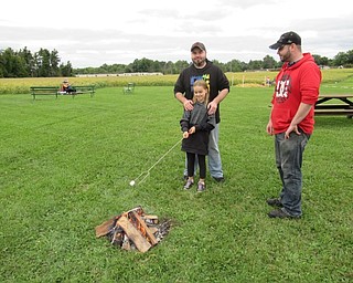 Neighbors | Jessica Harker.Lelay Hill roasted a marshmallow at one of the campfires set up during the Sunset at the Farm event Sept. 22.
