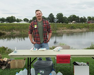Neighbors | Jessica Harker.MetroParks volunteer Ryan Walker handed out marshmallows at the annual Sunset at the Farms event Sept. 22.