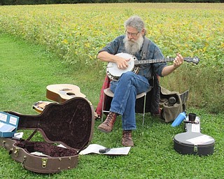 Neighbors | Jessica Harker.John Mosey played music to entertain community members as they roasted marshmallows around campfires at the Sunset at the Farm event Sept. 22.