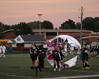 Neighbors | Abby Slanker.The six Canfield High School girls soccer team seniors led their team in running through a hoop banner prior to their game versus Boardman Lady Spartans during Senior Night on Sept. 26.