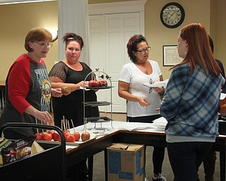 Neighbors | Jessica Harker.The Poland library offered a gourmet caramel apple event where community members were welcome to dip apples in caramel or chocolate and add candy and other toppings.