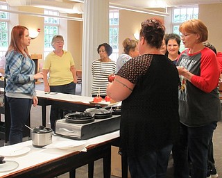 Neighbors | Jessica Harker.Community members dipped apples in caramel or chocolate at the Poland library Sept. 29.
