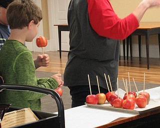 Neighbors | Jessica Harker.Community members chose apples that they got to dip in caramel or chocolate to create gourmet caramel apples at the Poland library Sept. 29.