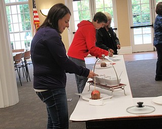 Neighbors | Jessica Harker.Librarian Karen Steed attended the Gourmet Apple event at the Poland library where she decorated her own caramel apple.