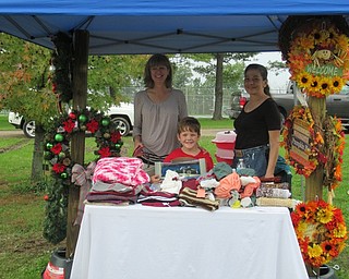 Neighbors | Jessica Harker.Kelly and Andrew Dunleavy along with Sue Garcias sold wreaths and other handmade goods at the Oktoberfest event at Austintown Park.