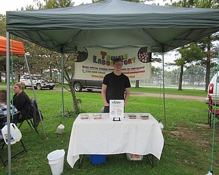 Neighbors | Jessica Harker.Sam Schultz, owner of Truffle Laboratory, sold his home made truffles at the Woodside Garden's Oktoberfest event.