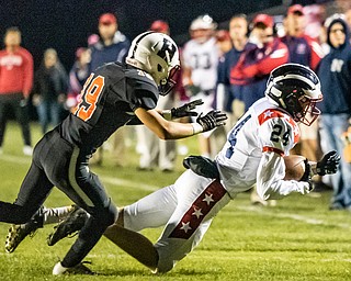 DIANNA OATRIDGE | THE VINDICATOR Niles'  Chase Sudzina (24) makes a reception as Howland's Anthony Ciarrochi (19) defends during their game at  Lombardo Field on Thursday.