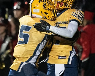 DIANNA OATRIDGE | THE VINDICATOR Youngstown East's DeRon Gilbert (17) celebrates with teammate GeiVonni Washington (5) in the end zone after scoring a touchdown during their game against Canfield at Rayen Stadium in Youngstown on Friday.