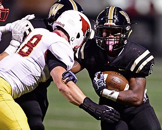 WARREN, OHIO - OCTOBER 12, 2018: Harding's Kayron Adams runs the ball while being hit by Mooney's Luke Fulton during the first half of their game, Friday night at Warren Harding High School. DAVID DERMER | THE VINDICATOR