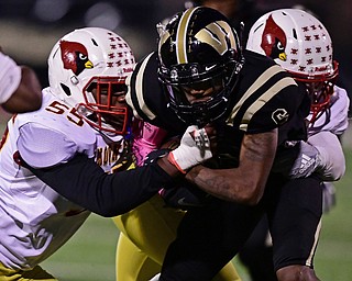 WARREN, OHIO - OCTOBER 12, 2018: Harding's Chris Chew is tackled by Mooney's Ammon Williams, left, and Lundy Stephaun during the first half of their game, Friday night at Warren Harding High School. DAVID DERMER | THE VINDICATOR