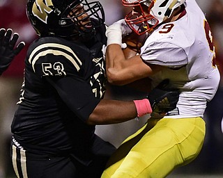 WARREN, OHIO - OCTOBER 12, 2018: Mooney's Jason Santisi is tackle by Harding's Jarriel White during the first half of their game, Friday night at Warren Harding High School. DAVID DERMER | THE VINDICATOR