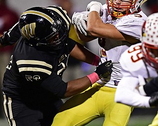 WARREN, OHIO - OCTOBER 12, 2018: Mooney's Jason Santisi is tackle by Harding's Jarriel White during the first half of their game, Friday night at Warren Harding High School. DAVID DERMER | THE VINDICATOR