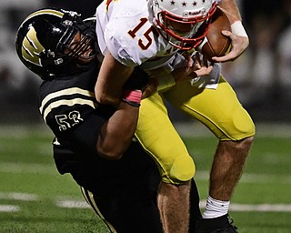 WARREN, OHIO - OCTOBER 12, 2018: Mooney's John Murphy is tackled by Harding's Jarriel White during the first half of their game, Friday night at Warren Harding High School. DAVID DERMER | THE VINDICATOR