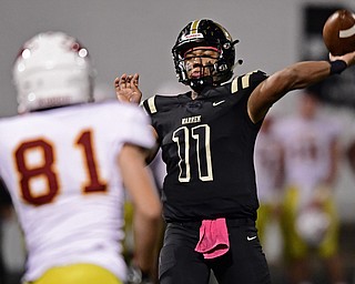 WARREN, OHIO - OCTOBER 12, 2018: Harding's Elijah Taylor throws a touchdown pass while avoiding pressure from Mooney's Anthony Fire during the second half of their game, Friday night at Warren Harding High School. DAVID DERMER | THE VINDICATOR