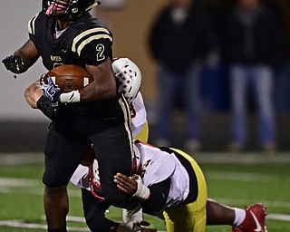 WARREN, OHIO - OCTOBER 12, 2018: Harding's Kayron Adams is brought down by Mooney's Luke Fulton and Ammon Williams during the second half of their game, Friday night at Warren Harding High School. DAVID DERMER | THE VINDICATOR