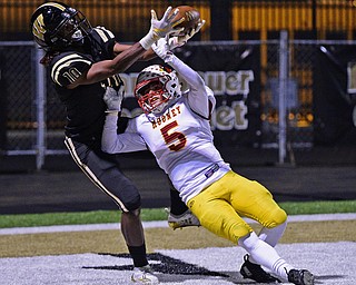 WARREN, OHIO - OCTOBER 12, 2018: Harding's Jakari Salter catches a touchdown pass over Mooney's Nico Marchionda during the second half of their game, Friday night at Warren Harding High School. DAVID DERMER | THE VINDICATOR