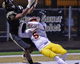 WARREN, OHIO - OCTOBER 12, 2018: Harding's Jakari Salter catches a touchdown pass over Mooney's Nico Marchionda during the second half of their game, Friday night at Warren Harding High School. DAVID DERMER | THE VINDICATOR