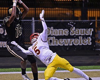 WARREN, OHIO - OCTOBER 12, 2018: Harding's Jakari Salter catches a touchdown pass over Mooney's Nico Marchionda during the second half of their game, Friday night at Warren Harding High School. DAVID DERMER | THE VINDICATOR