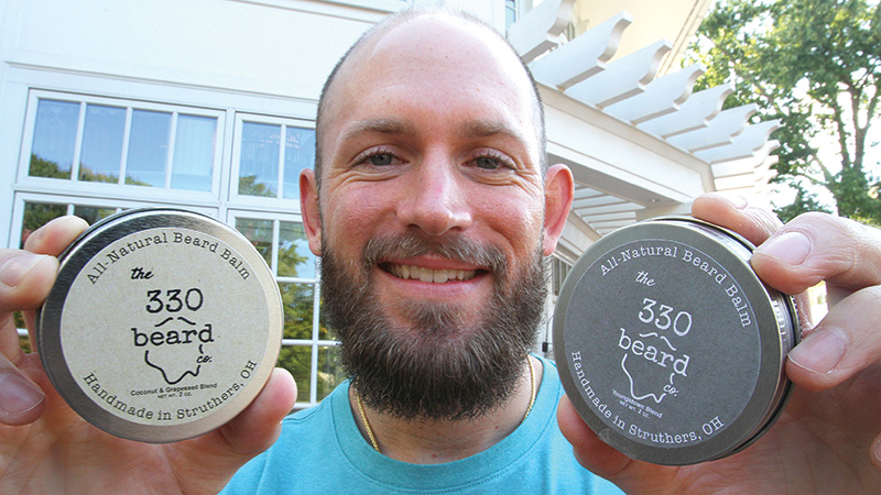 Local teacher Bill Grischow shows off some of the beard balm products he's created for his business 330 Beard Co.