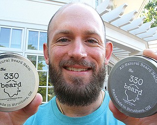 Local teacher Bill Grischow shows off some of the beard balm products he's created for his business 330 Beard Co.