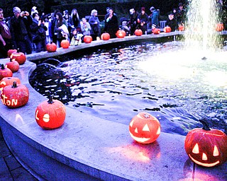 Pumpkins are displayed around the fountain at the Pumpkin Walk at Twilight at Fellows Riverside Gardens on Sunday. EMILY MATTHEWS | THE VINDICATOR