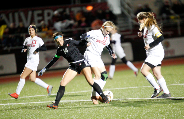 Mooney's Bre Evans and Struthers' Grace Bishop fight over control over the ball during their game at Farmers National Bank Soccer Field on Monday. EMILY MATTHEWS | THE VINDICATOR