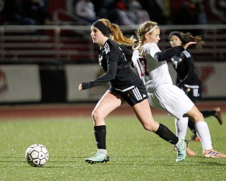 Mooney's Grace Venturella gets the ball past Struthers' Grace Bishop during their game at Farmers National Bank Soccer Field on Monday. EMILY MATTHEWS | THE VINDICATOR