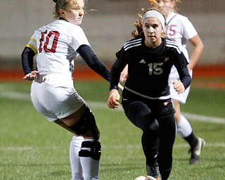 Mooney's Anna Wollet runs the ball past Struthers' Sabrina Bartholomew during their game at Farmers National Bank Soccer Field on Monday. EMILY MATTHEWS | THE VINDICATOR