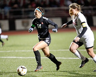 Mooney's Bre Evans runs the ball past Struthers' Emilee Styranec during their game at Farmers National Bank Soccer Field on Monday. EMILY MATTHEWS | THE VINDICATOR