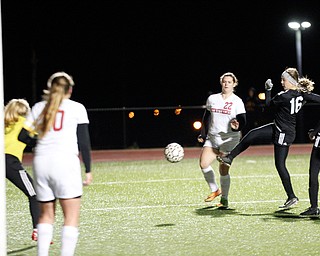 Mooney's Ava Szalay kicks the ball past Struthers' Lauryn Steele and toward the goal during their game at Farmers National Bank Soccer Field on Monday. EMILY MATTHEWS | THE VINDICATOR