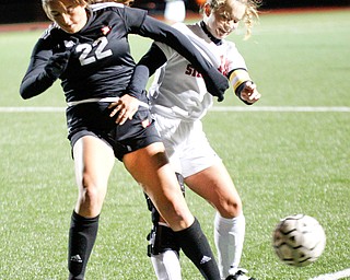 Mooney's Kayla Jadue and Struthers' Sabrina Bartholomew go after the ball during their game at Farmers National Bank Soccer Field on Monday. EMILY MATTHEWS | THE VINDICATOR