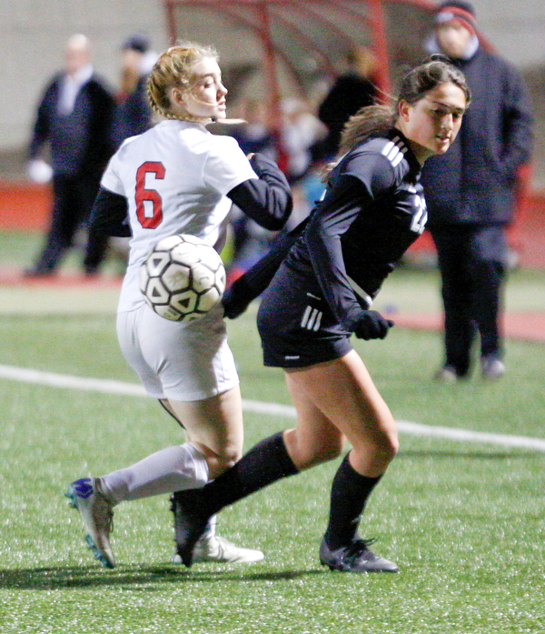Mooney's Kayla Jadue and Struthers' Madison Norberg turn to go after the ball during their game at Farmers National Bank Soccer Field on Monday. EMILY MATTHEWS | THE VINDICATOR