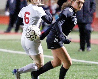 Mooney's Kayla Jadue and Struthers' Madison Norberg turn to go after the ball during their game at Farmers National Bank Soccer Field on Monday. EMILY MATTHEWS | THE VINDICATOR