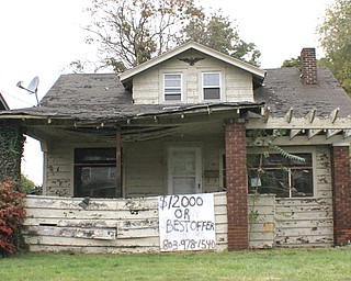 A crudely drawn sign offering low-cost home ownership displays the phone number of Vision Property Management, a Columbia, S.C., real-estate management company that purchases and resells homes – many that look like this – to individuals who wish to own a home but struggle to find financing. Community Legal Aid has sued Vision for alleged fraud and breach of contract.