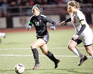 Bre Evans of Cardinal Mooney High School runs the ball past Emilee Styranec of Struthers High School during their soccer match at Farmers National Bank Soccer Field on Monday. Mooney won 16-0.