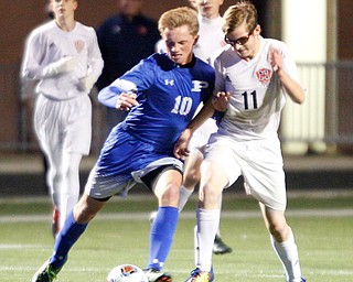 Poland's Adam Rumble takes the ball away from Niles' Casey Flynn during the first half of their game at Poland on Tuesday. EMILY MATTHEWS | THE VINDICATOR
