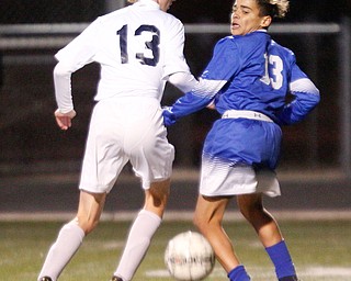 Poland's Justice Gonzalez and Niles' Tristian DelVecchio go after the ball during the first half of their game at Poland on Tuesday. EMILY MATTHEWS | THE VINDICATOR