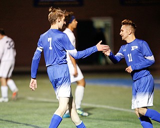 Poland's Rocco Parente, left, and Jake Bacon high five after Bacon scores a goal against Niles during the first half of their game at Poland on Tuesday. EMILY MATTHEWS | THE VINDICATOR