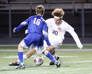 Niles' Vela Carter tries to keep the ball away from Poland's Bill Ghinda during the first half of their game at Poland on Tuesday. EMILY MATTHEWS | THE VINDICATOR